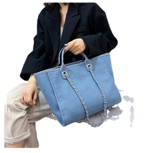 Blue denim tote bag for women featuring silver chain strap and dual top handles