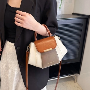 Chic tricolor patchwork handbag with trapezoidal pleats and elegant round top handles