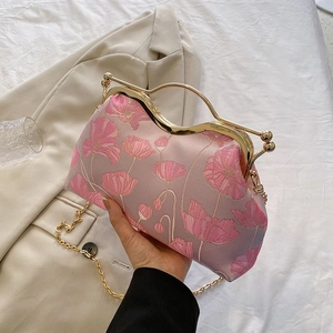 Pink floral embroidered handbag with golden wave handle and elegant chain strap