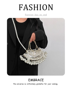 Detail showing the pearl cage structure with metallic inner pouch and elegant long strap