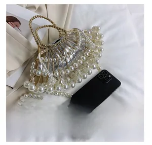 Detail presentation of fan-shaped pearl evening bag with gold frame and drawstring inner