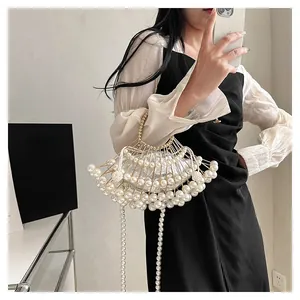 Detailed fan-shaped pearl evening clutch bag with gold frame and elegant tassels