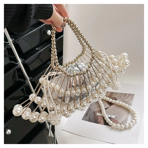 Detail of a fan-shaped cage bag with pearl accents and a silver drawstring pouch inside