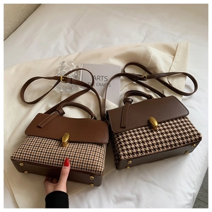 Detail of vintage houndstooth plaid handbags with golden twist locks and leather straps