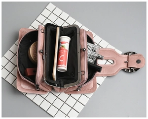 Detail view of pink leather crossbody bag showing multiple inner compartments and storage space