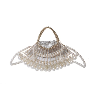 Handmade fan-shaped pearl evening bag with gold metal frame and silver drawstring pouch