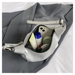 Top view of silver-gray pleated handbag interior showing spacious storage for daily items