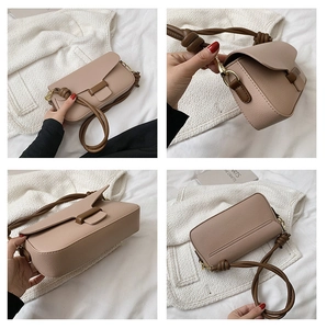 Detail of pink faux leather handbag with contrast brown knotted strap and gold hardware
