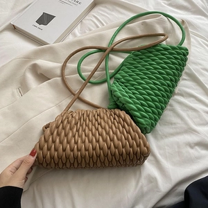 Detail of woven bubble texture handbags in green and khaki with thin shoulder straps