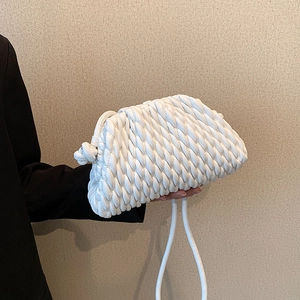 Detail of white woven cloud pouch bag with ruched texture and slim drawstring strap