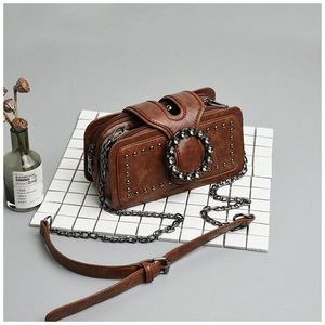 Vintage brown chain bag with dark nickel studs and a rhinestone-encrusted round buckle