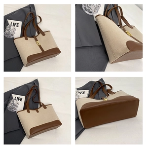 Detail of canvas tote bag with brown leather trim and golden twist lock closure
