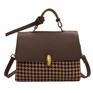 Retro houndstooth plaid handbag with brown leather flap and gold clasp on white background