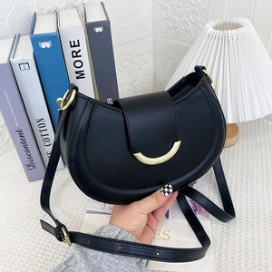 Minimalist black crescent shoulder bag with golden hardware and adjustable strap