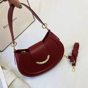 Deep red crescent shoulder bag with gold hardware and adjustable strap for women