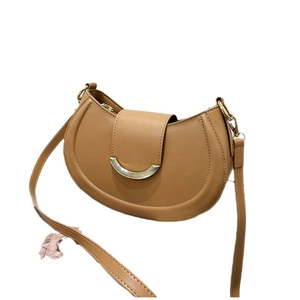 Classic brown saddle bag with golden crescent buckle and adjustable strap