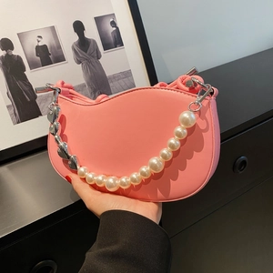 Pink crescent shoulder bag with large pearl and heart metal chain strap