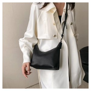 Black striped crescent moon bag with pleated leather texture and gold hardware details