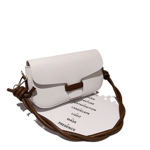 Minimalist cream white pebble leather crossbody bag with brown buckle and knotted strap