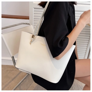 Chic beige leather tote bag with gold metal hooks and shoulder strap for daily commuting