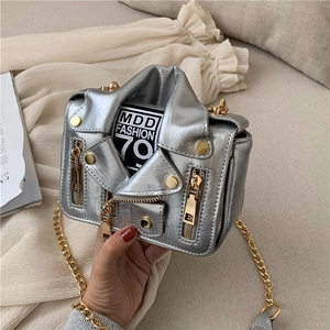 Detail of silver biker jacket bag featuring metallic finish zippers and chain strap