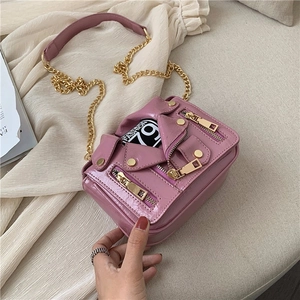 Pink motorcycle jacket crossbody bag with metallic zippers and golden chain strap