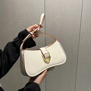 Detail of off-white leather shoulder bag with gold D-ring buckle and brown oil edges