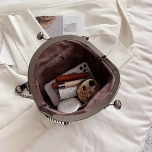 Top view of pearl evening handbag interior showing capacity for cosmetics and phone