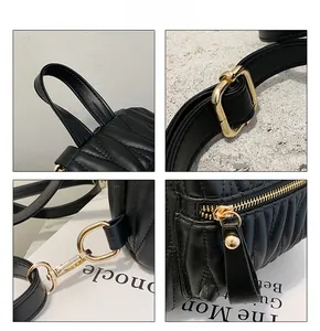 Detail view of black quilted leather backpack with gold-tone hardware and V-shaped stitching