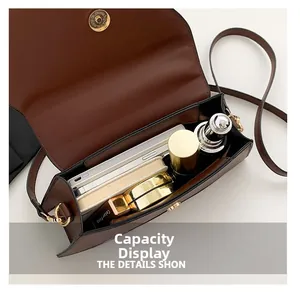 Detail view of the spacious interior of a brown crocodile pattern PU leather crossbody bag