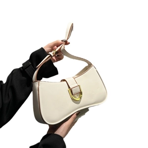 Chic beige crescent-shaped leather shoulder bag with gold hardware and brown edges