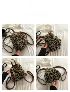 Detailed views of mini leopard print backpack with brown leather straps and gold zippers