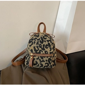 Close-up of leopard print mini backpack showing texture and golden zipper detail