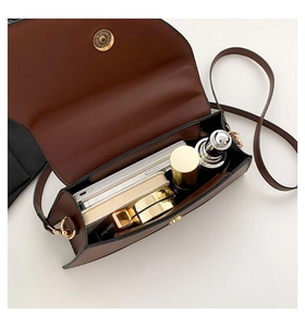 Interior view of brown faux leather crossbody bag showing spacious storage and magnetic clasp