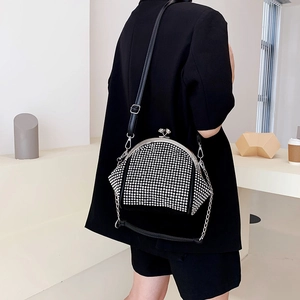 Sparkly rhinestone-studded clutch bag with silver metal frame and adjustable strap