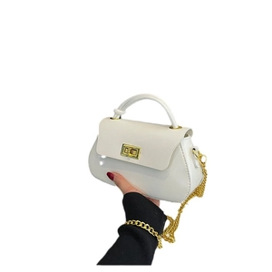 Minimalist white semi-circle leather bag with gold chain strap and top handle