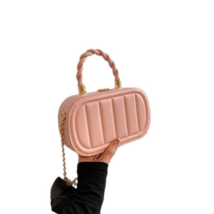 Pink quilted crossbody bag with vertical wave pattern and gold metal chain strap