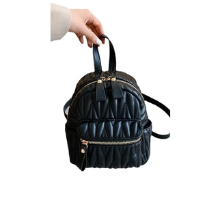 Quilted black leather backpack for women with gold hardware and top handle design