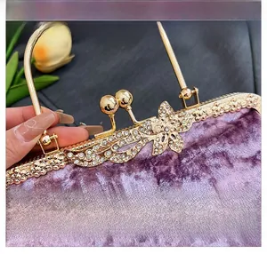 Detail of lavender velvet evening bag with gold butterfly clasp and sparkling rhinestones