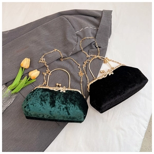 Detail of velvet evening bags with gold handles and floral rhinestone clasp ornaments