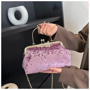 Detail of lavender velvet evening bag with gold handle and sparkling diamond butterfly clasp