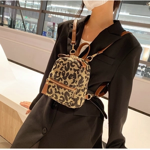 Women's leopard print mini backpack and crossbody bag with brown leather trim details