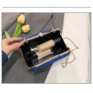 Blue glitter evening bag interior capacity showing phone, lipstick and makeup items
