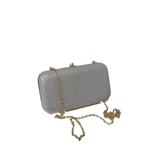Sparkling silver glitter evening clutch bag with gold metal chain strap for women