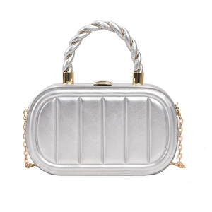 Detail of silver metallic box bag featuring vertical stripes and gold chain strap