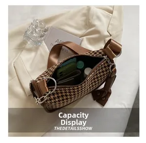 Interior storage capacity showing daily items inside the houndstooth crossbody bag