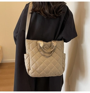 Detailed back view of a khaki quilted tote bag with diamond stitching and wide strap
