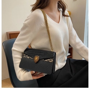 Chic black chain shoulder bag with crocodile texture and golden lion head clasp