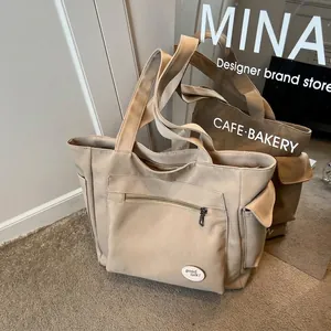 Versatile khaki canvas tote bag with multiple pockets and good luck embroidery