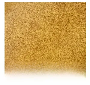 Macro detail of brown lychee grain leather texture on high-quality women's handbag